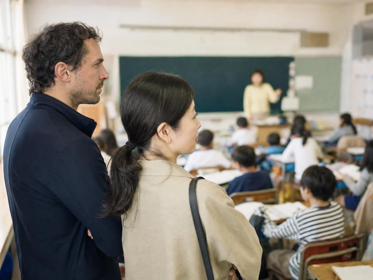 parents watch a lesson from the back of an elementary classroom